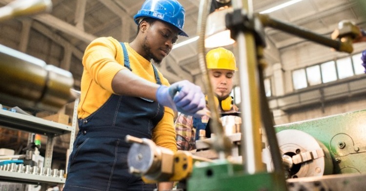 Tow men in hard hats machining