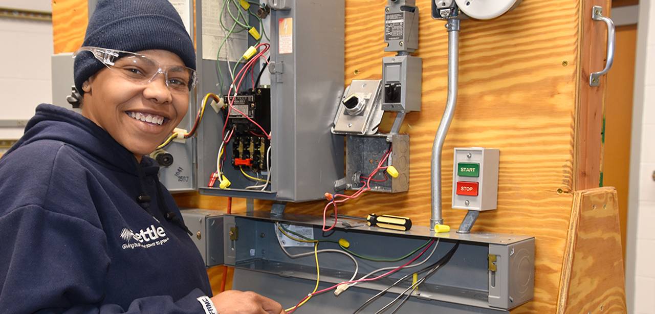 Woman working at electrical board